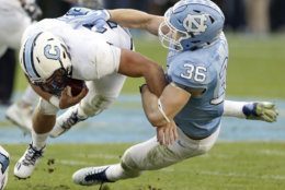 North Carolina's Cole Holcomb (36) tackles The Citadel's Tyler Renew during the first half of an NCAA college football game in Chapel Hill, N.C., Saturday, Nov. 19, 2016. (AP Photo/Gerry Broome)