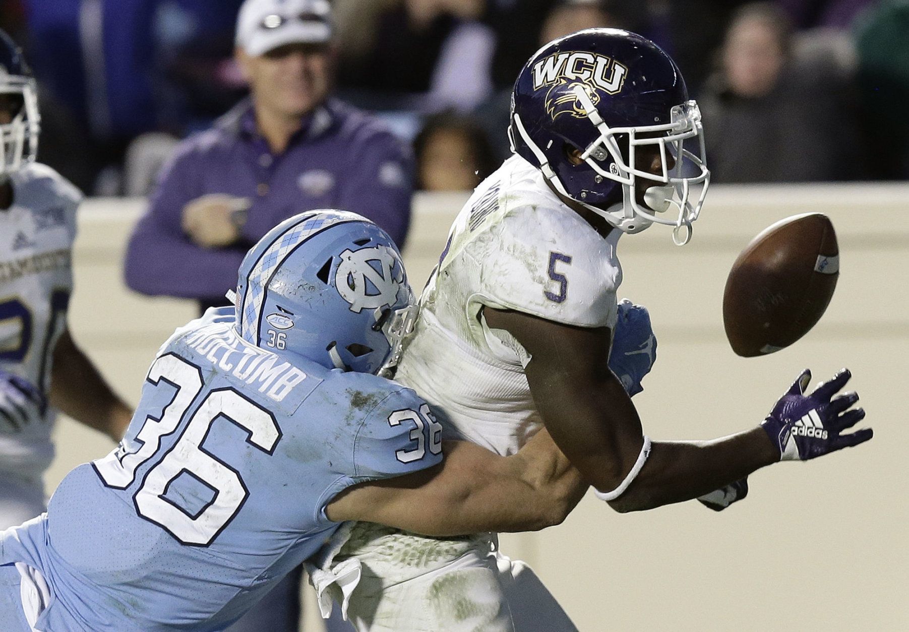 North Carolina's Cole Holcomb (36) hits Western Carolina's Connell Young (5) to cause a fumble during the second half of an NCAA college football game in Chapel Hill, N.C., Saturday, Nov. 17, 2018. North Carolina won 49-26. (AP Photo/Gerry Broome)