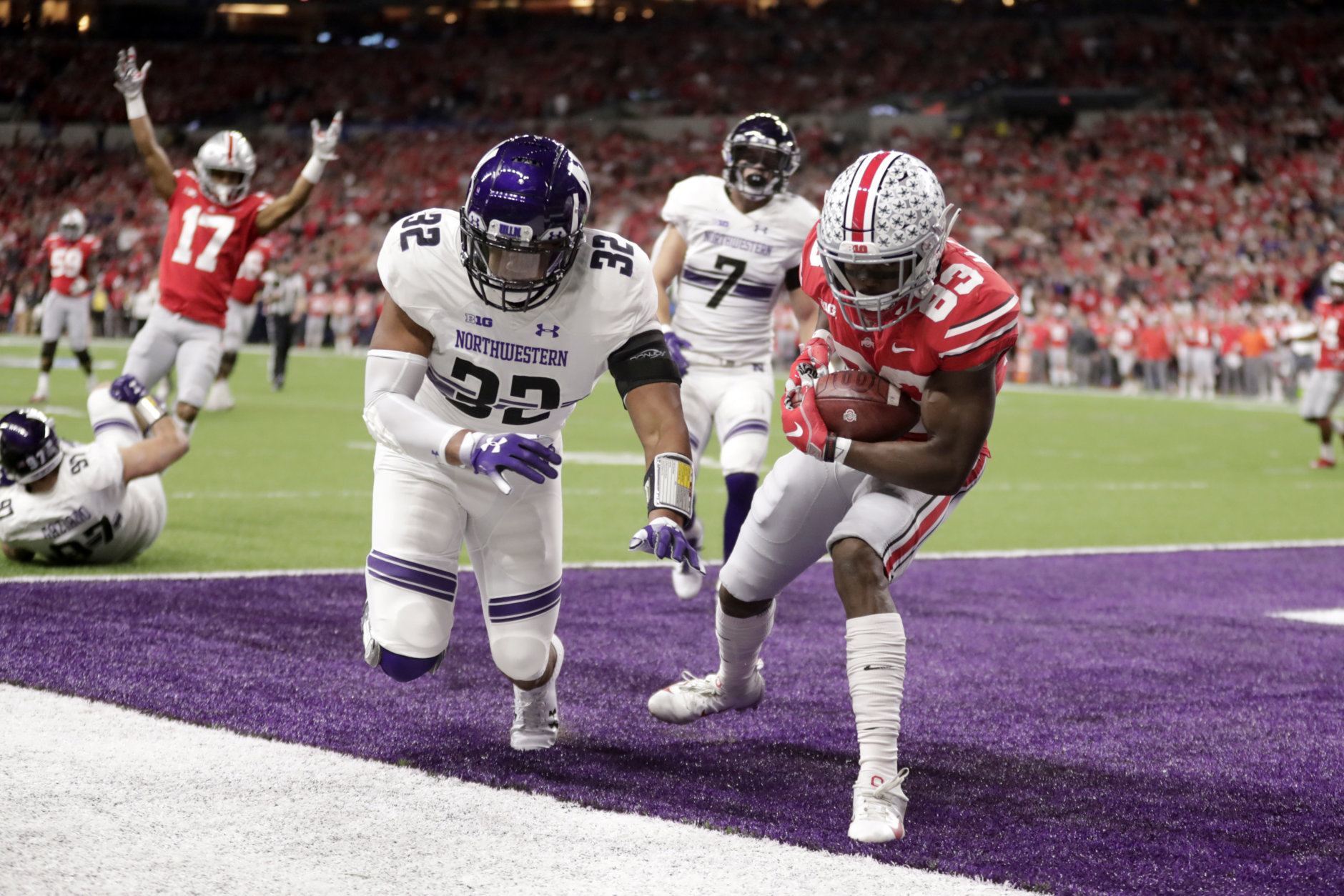 Ohio State's Terry McLaurin (83) makes a touchdown reception against Northwestern's Nate Hall (32) during the first half of the Big Ten championship NCAA college football game, Saturday, Dec. 1, 2018, in Indianapolis. (AP Photo/Michael Conroy)