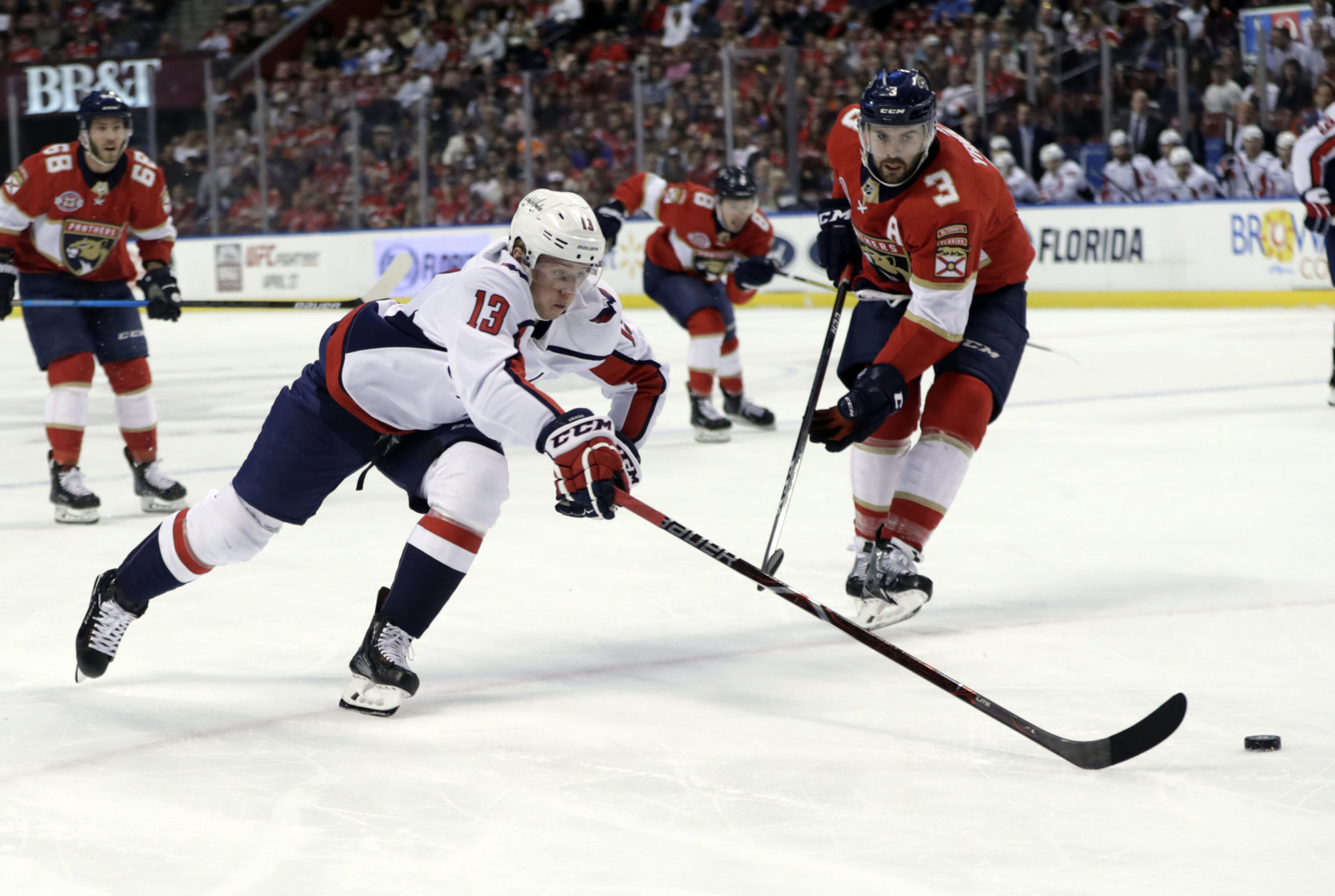 Washington Capitals left wing Jakub Vrana (13) skates with the puck as Florida Panthers defenseman Keith Yandle (3) pursues during the first period of an NHL hockey game, Monday, April 1, 2019, in Sunrise, Fla. (AP Photo/Lynne Sladky)