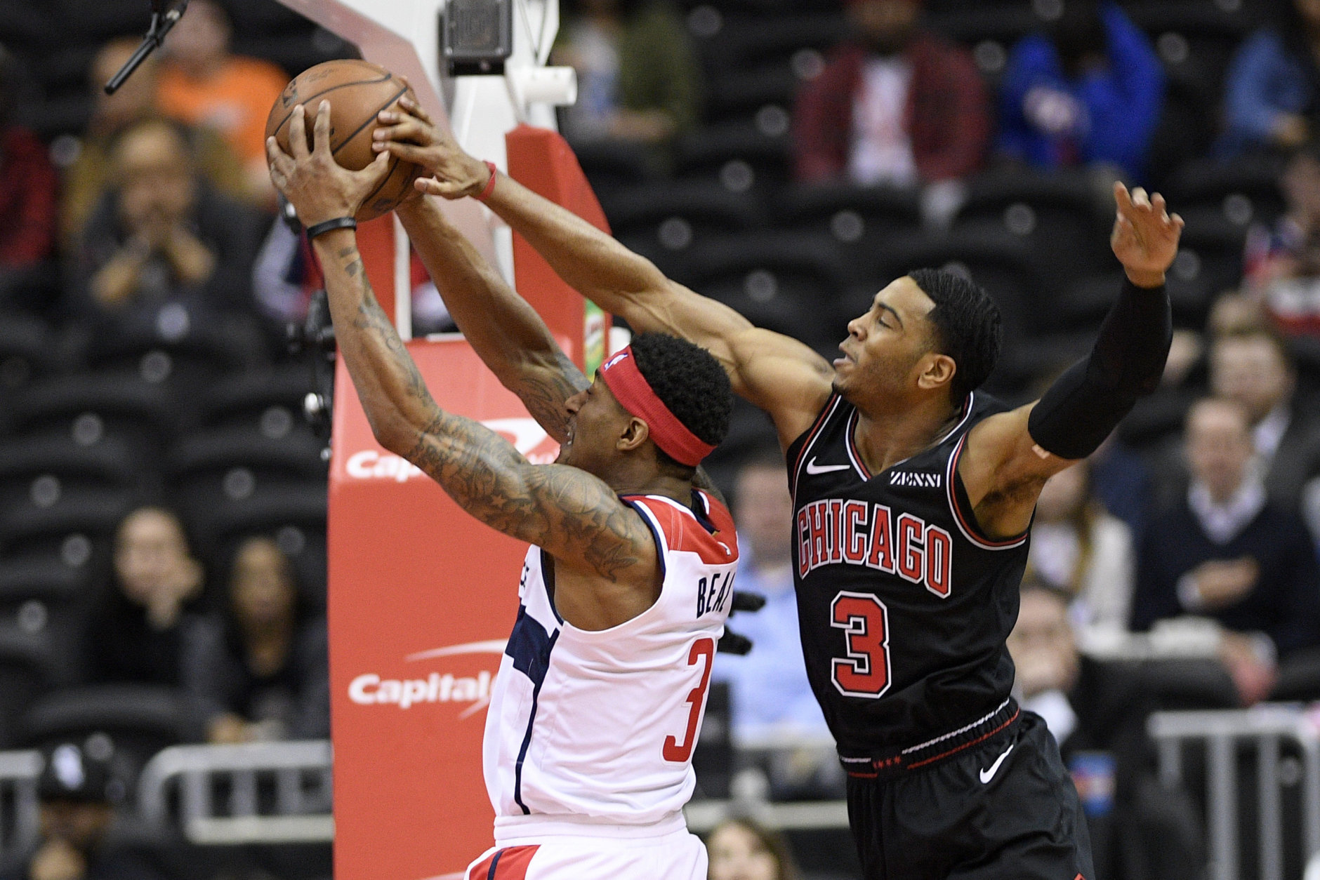 Washington Wizards guard Bradley Beal, left, goes to the basket against Chicago Bulls guard Shaquille Harrison, right, during the first half of an NBA basketball game, Wednesday, April 3, 2019, in Washington. (AP Photo/Nick Wass)