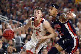 Virginia's Kyle Guy (5) drives against Auburn's Bryce Brown (2) during the first half in the semifinals of the Final Four NCAA college basketball tournament, Saturday, April 6, 2019, in Minneapolis. (AP Photo/Jeff Roberson)