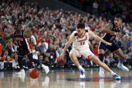 Virginia guard Ty Jerome (11) runs down a loose ball ahead of Auburn guard Bryce Brown, right, during the second half in the semifinals of the Final Four NCAA college basketball tournament, Saturday, April 6, 2019, in Minneapolis. (AP Photo/Jeff Roberson)
