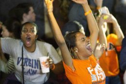 Virginia fans celebrate their teams win of the championship of the Final Four NCAA college basketball tournament against Texas Tech, at a bar near the school in Richmond, Va., Monday, April 8, 2019. (AP Photo/Steve Helber)