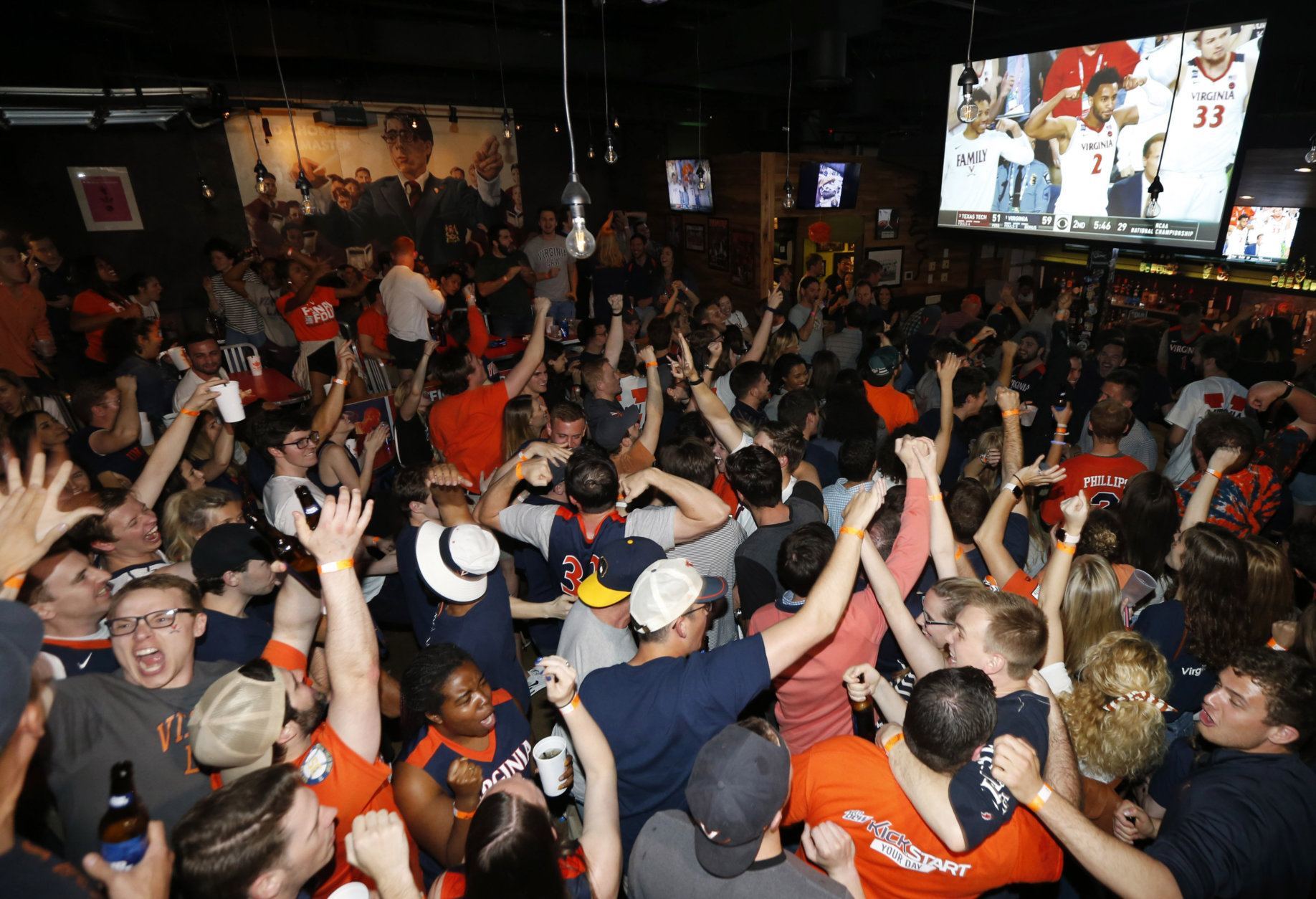 Virginia fans celebrate their team's win in the championship of the Final Four NCAA college basketball tournament against Texas Tech Monday, April 8, 2019. (AP Photo/Steve Helber)