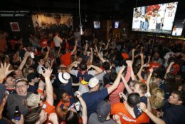 Virginia fans celebrate their team's win in the championship of the Final Four NCAA college basketball tournament against Texas Tech Monday, April 8, 2019. (AP Photo/Steve Helber)