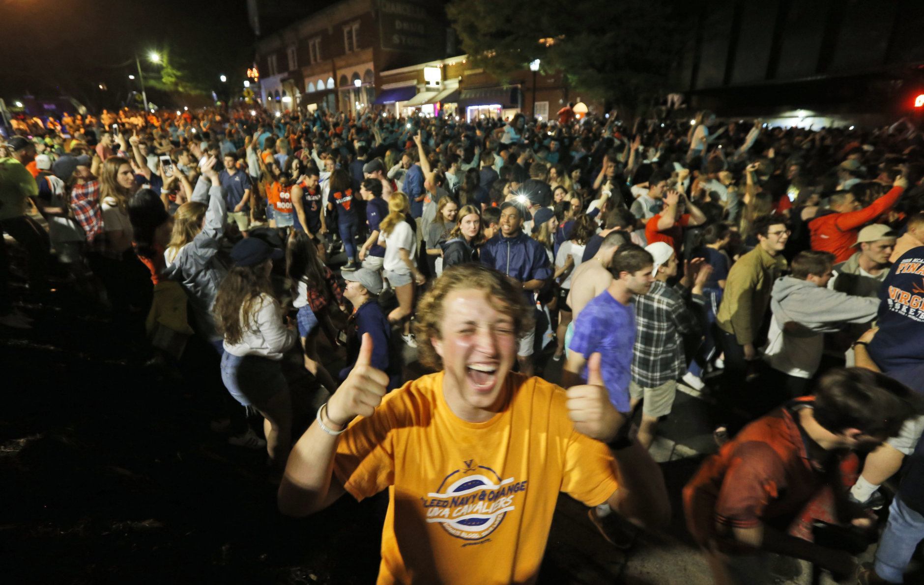 Virginia fans celebrate their team's win in the championship of the Final Four NCAA college basketball tournament against Texas Tech, at an intersection near the school in Richmond, Va., Monday, April 8, 2019. (AP Photo/Steve Helber)