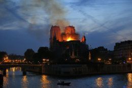Firefighters tackle the blaze as flames and smoke rise from Notre Dame cathedral as it burns in Paris, Monday, April 15, 2019. Massive plumes of yellow brown smoke is filling the air above Notre Dame Cathedral and ash is falling on tourists and others around the island that marks the center of Paris. (AP Photo/Michel Euler)