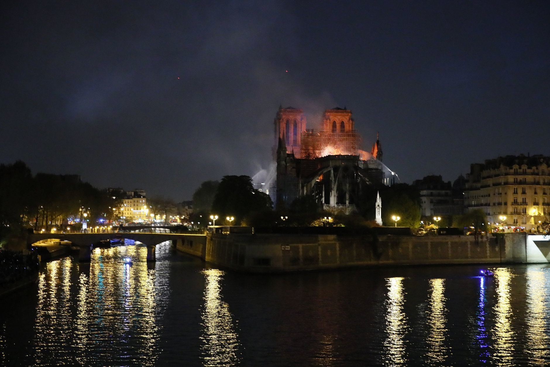 Notre Dame cathedral is seen burning in Paris, Monday, April 15, 2019. A catastrophic fire engulfed the upper reaches of Paris' soaring Notre Dame Cathedral as it was undergoing renovations Monday, threatening one of the greatest architectural treasures of the Western world as tourists and Parisians looked on aghast from the streets below. (AP Photo/Francois Mori)