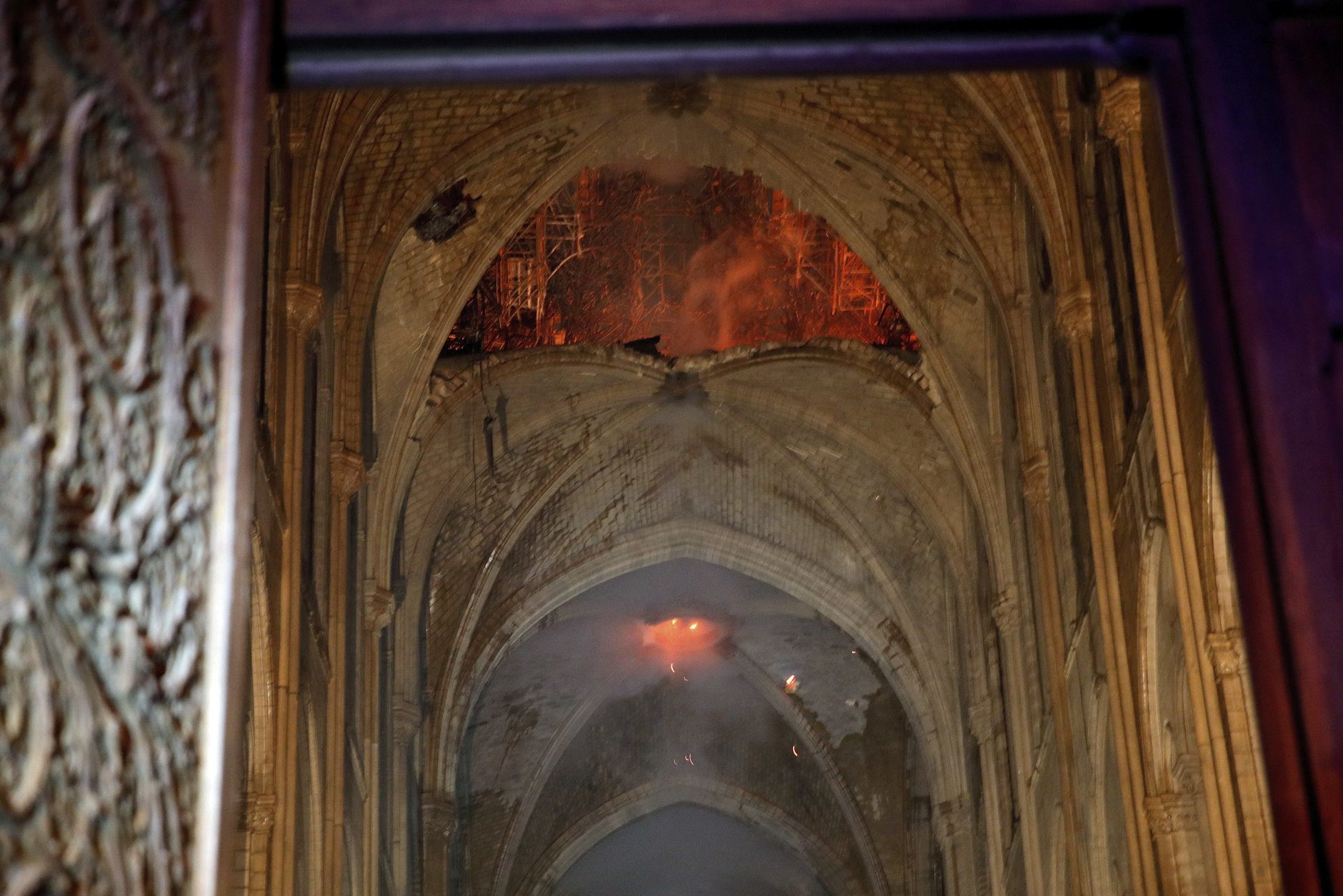 Flames and smoke are seen as the interior at Notre Dame cathedral in Paris, Monday, April 15, 2019. A catastrophic fire engulfed the upper reaches of Paris' soaring Notre Dame Cathedral as it was undergoing renovations Monday, threatening one of the greatest architectural treasures of the Western world as tourists and Parisians looked on aghast from the streets below. (Philippe Wojazer/Pool via AP)