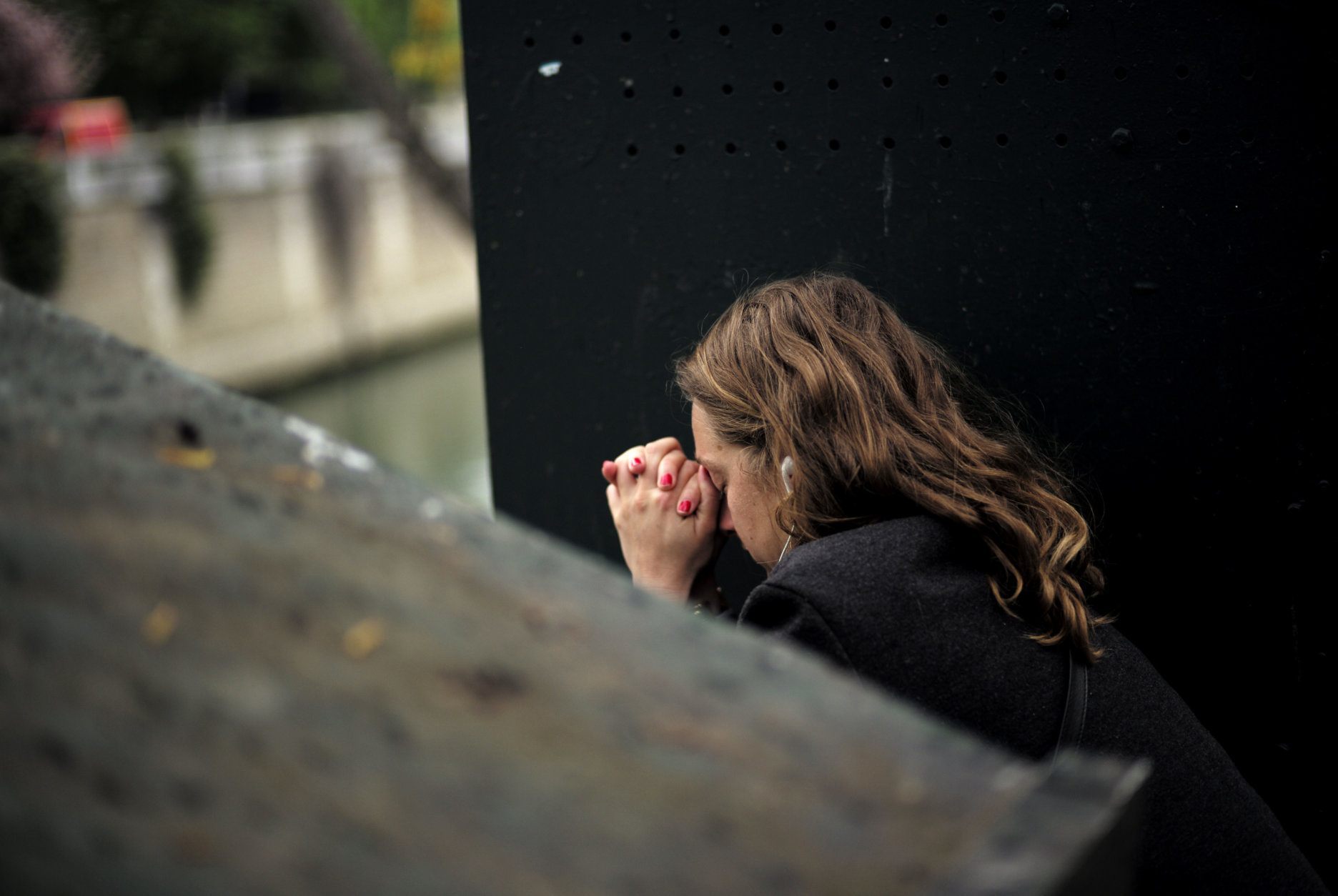 A woman sits in despair near the Notre Dame cathedral after the fire in Paris, Tuesday, April 16, 2019. A catastrophic fire engulfed the upper reaches of Paris' soaring Notre Dame Cathedral as it was undergoing renovations Monday, threatening one of the greatest architectural treasures of the Western world as tourists and Parisians looked on aghast from the streets below. (AP Photo/Kamil Zihnioglu)