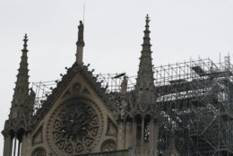 View of the Notre Dame cathedral after the fire in Paris, Tuesday, April 16, 2019. Experts are assessing the blackened shell of Paris' iconic Notre Dame cathedral to establish next steps to save what remains after a devastating fire destroyed much of the almost 900-year-old building. With the fire that broke out Monday evening and quickly consumed the cathedral now under control, attention is turning to ensuring the structural integrity of the remaining building. (AP Photo/Christophe Ena)