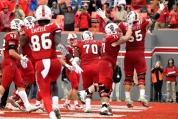 RALEIGH, NC - DECEMBER 01: Garrett Bradbury #65 of the North Carolina State Wolfpack celebrates with teammates following a one-yard touchdown run against the East Carolina Pirates in the fourth quarter at Carter-Finley Stadium on December 1, 2018 in Raleigh, North Carolina. NC State won 58-3. (Photo by Lance King/Getty Images)