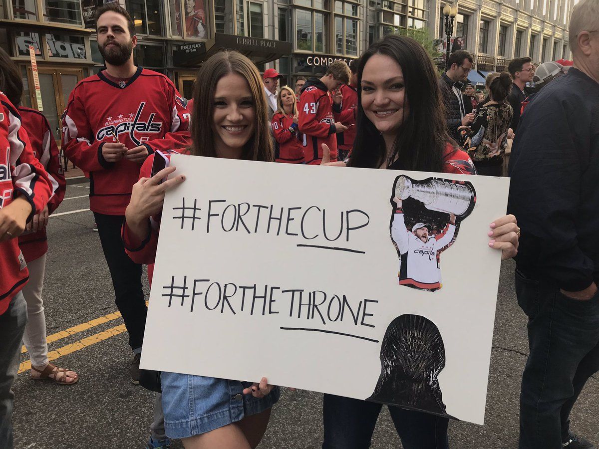 Fans outside Capital One Arena hold up a Game of Thrones-themed sign before the Caps host the Hurricanes in Game 7. (WTOP/Michelle Basch)