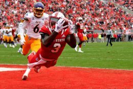 RALEIGH, NC - DECEMBER 01: Kelvin Harmon #3 of the North Carolina State Wolfpack catches a pass for a 14-yard touchdown against Marcus Holton Jr. #6 of the East Carolina Pirates in the first quarter at Carter-Finley Stadium on December 1, 2018 in Raleigh, North Carolina. (Photo by Lance King/Getty Images)