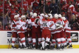 WASHINGTON, DC - APRIL 24: The Carolina Hurricanes celebrate victory over the Washington Capitals in Game Seven of the Eastern Conference First Round during the 2019 NHL Stanley Cup Playoffs at the Capital One Arena on April 24, 2019 in Washington, DC. The Hurricanes defeated the Capitals 4-3 in the second overtime period to move on to Round Two of the Stanley Cup playoffs. (Photo by Patrick Smith/Getty Images)