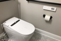 The motion detectors enable the toilet seat cover to automatically raise and lower, and clean the toilet. (WTOP/Neal Augenstein)