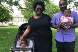 Javona Brownlee and Jonathan Ware came to the rally with their daughters Kenzie, 2, (in stroller) and Knoble, 7 months. Brownlee said it has been a struggle to find affordable day care in the District, where they live. D.C. has the highest day care costs in the country. (WTOP/Mitchell Miller)