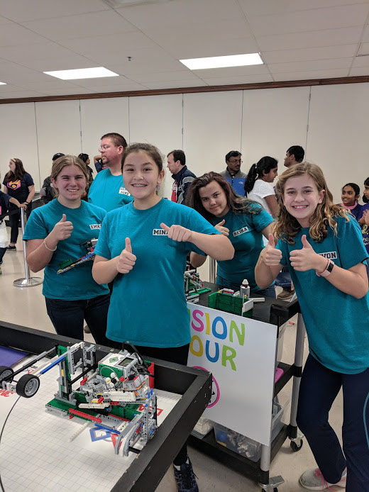 The Fusion Four team gives a thumbs-up after a successful robot practice run at the regional competition at Hayfield High School. (Courtesy Merrie Joy Hrabak)