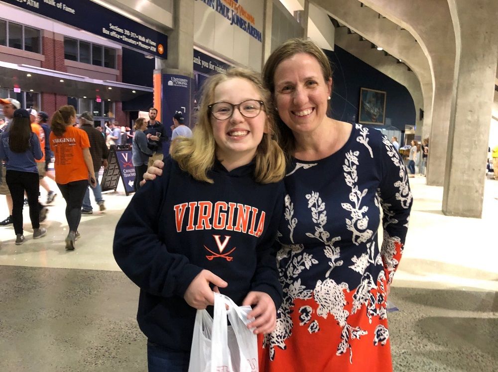 Angelique Wynkoop  and her 12-year-old daughter, Ellie, wait to welcome home the Cavaliers Tuesday, April 10, 2019. (WTOP/Kristi King)
