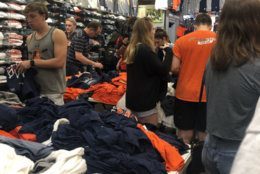 The line to get championship Virginia gear was long as fans anticipated the team's return Tuesday, April 9, 2019. (WTOP/Joslyn Chesson)