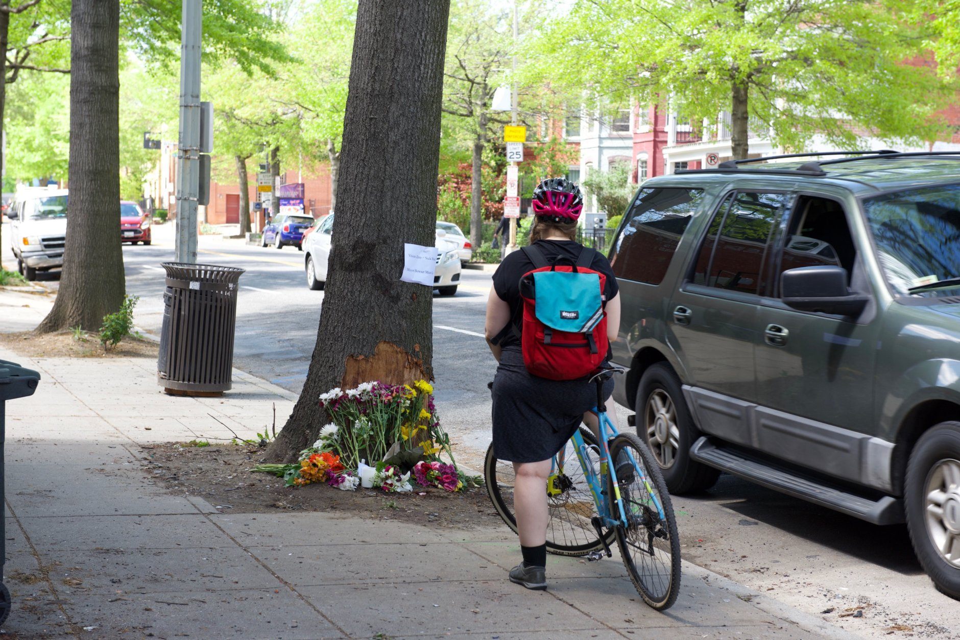 A cyclist stops at the crash scene where D.C. cycling advocate Dave Salovesh was killed on Friday. (WTOP/Kate Ryan)