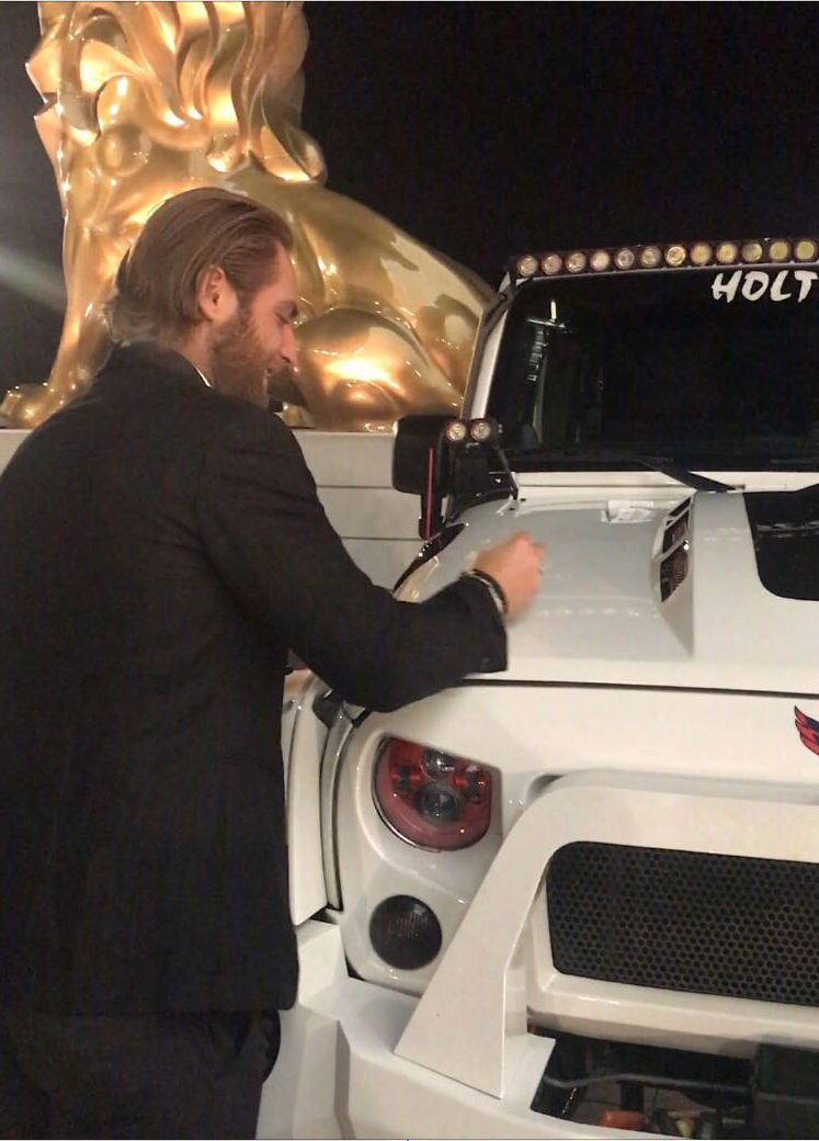 Braden Holtby signs the Caps Jeep. (Courtesy Ed Twomey) 