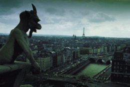 A Notre Dame gargoyle looks over the city of Paris, Dec. 1966.  In the background is the Eiffel Tower.  (AP Photo)