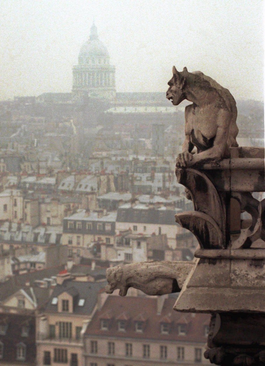A chimera and a gargoyle watch over Paris from the top of the 11th century Notre Dame cathedral, Jan. 10, 1996. Architect Viollet le Duc added the chimeras and gargoyles to the tower walls when repairing the damages caused by the French Revolution. The chimeras are purely decorative while the garoyles were built to serve as raingutters. (AP Photo/Remy De La Mauviniere)