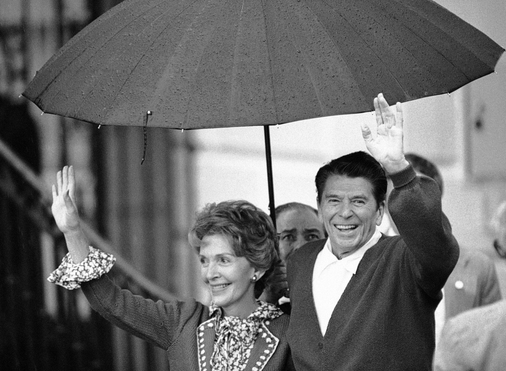 President Ronald Reagan and Mrs. Nancy Reagan wave to members of the White House staff on the South Lawn in Washington  Saturday, April 11, 1981. Reagan returned to the Executive Mansion after 12 days in the hospital recovering from a shot by a would-be assassin. (AP Photo)