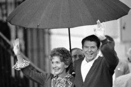President Ronald Reagan and Mrs. Nancy Reagan wave to members of the White House staff on the South Lawn in Washington  Saturday, April 11, 1981. Reagan returned to the Executive Mansion after 12 days in the hospital recovering from a shot by a would-be assassin. (AP Photo)