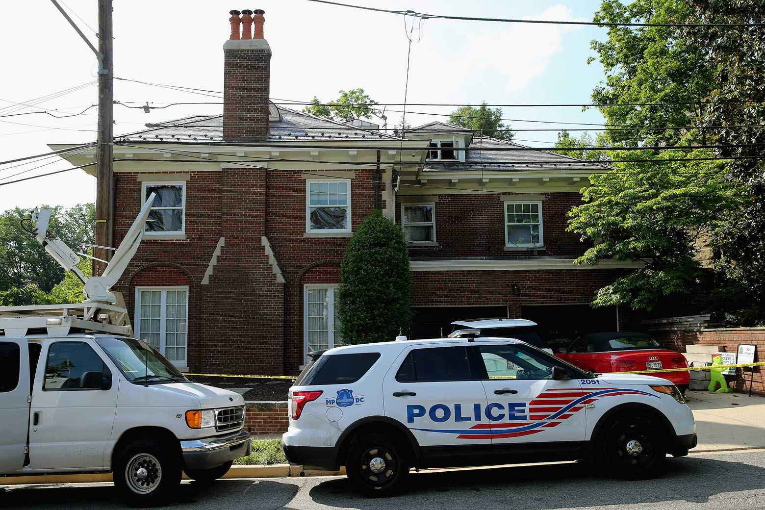 WASHINGTON, DC - MAY 19:  District of Columbia Metropolitan Police maintain a perimeter around the house on the 3200 block of Woodland Drive NW May 19, 2015 in Washington, DC. Firefighters discovered the bodies of Savvas Savopoulos, 46, his wife Amy, 47, their 10-year-old son Philip, and the housekeeper, Veralicia Figueroa, 57, last Thursday afternoon when they responded to a blaze at the house. Two Savopoulos daughters were away in boarding school at the time. Investigators have ruled the deaths homicides and say they could continue to collect evidence at the house for another week.  (Photo by Chip Somodevilla/Getty Images)