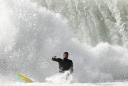 A surfer falls on a wave at Blacks Beach Friday, Jan. 19, 2018, in San Diego. A winter storm swept into California Friday, bringing large waves to the coast, and much-needed snow in higher elevations of the Sierra Nevada. (AP Photo/Gregory Bull)