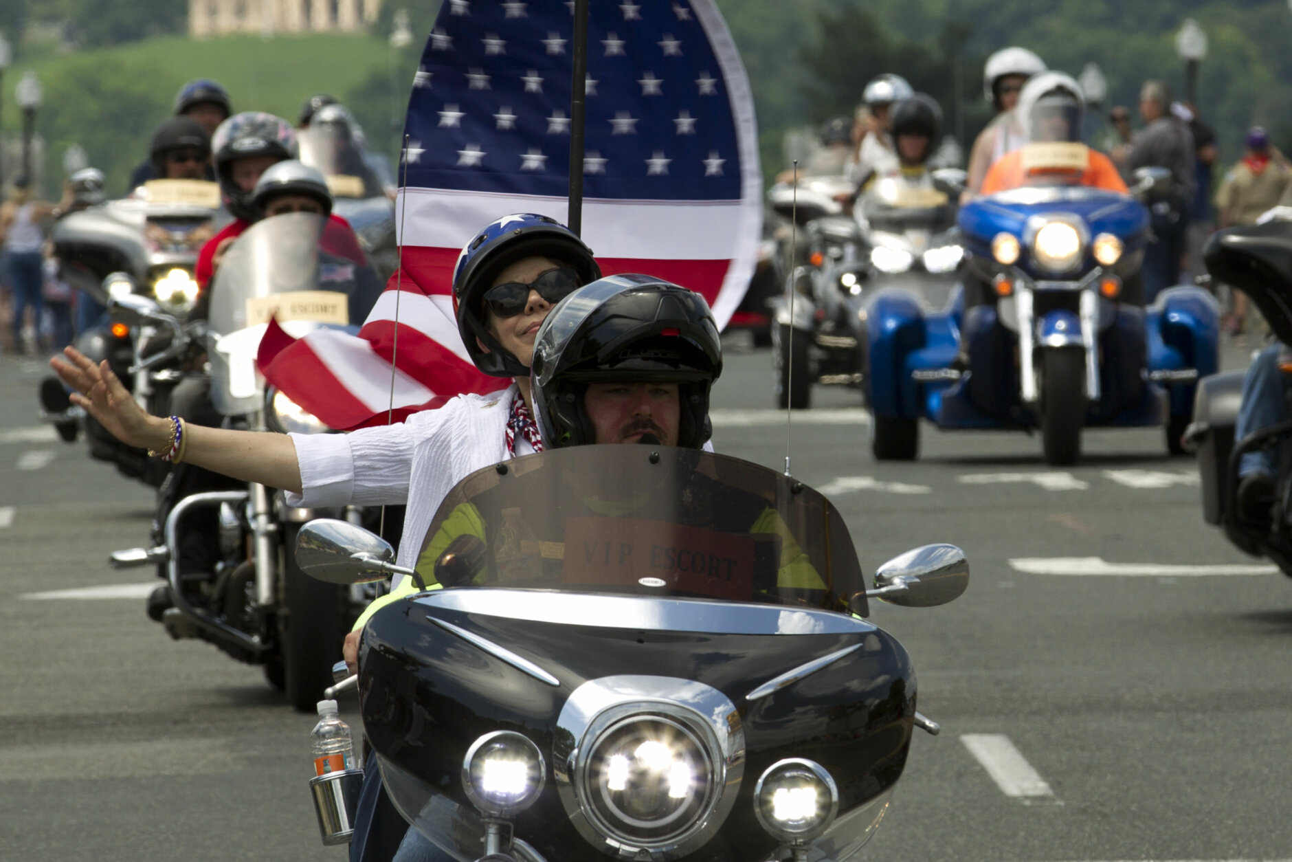 Participants in the Rolling Thunder motorcycle rally waves to the crowds as they ride past Arlington Memorial Bridge, during the annual Rolling Thunder parade, ahead of Memorial Day on Sunday, May 27, 2018, in Washington. (AP Photo/Jose Luis Magana)