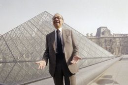 FILE - In this March 29, 1989, file photo, Chinese-American architect I.M. Pei laughs while posing for a portrait in front of the Louvre glass pyramid, which he designed, in the museum's Napoleon Courtyard, prior to its inauguration in Paris. Pei, the globe-trotting architect who revived the Louvre museum in Paris with a giant glass pyramid and captured the spirit of rebellion at the multi-shaped Rock and Roll Hall of Fame, has died at age 102, a spokesman confirmed Thursday, May 16, 2019. (AP Photo/Pierre Gleizes, File)