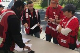 Volunteers — like these from last week in Capital Heights, Maryland — give out fire safety information and install free smoke alarms. (Courtesy National Capitol Region American Red Cross/Paul Carden)