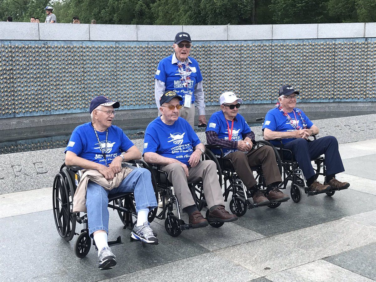 Some of the veterans from the Midwest Honor Flight pose at the WWII Memorial.  Int total, 82 veterans made the trip. (WTOP/Michelle Basch)