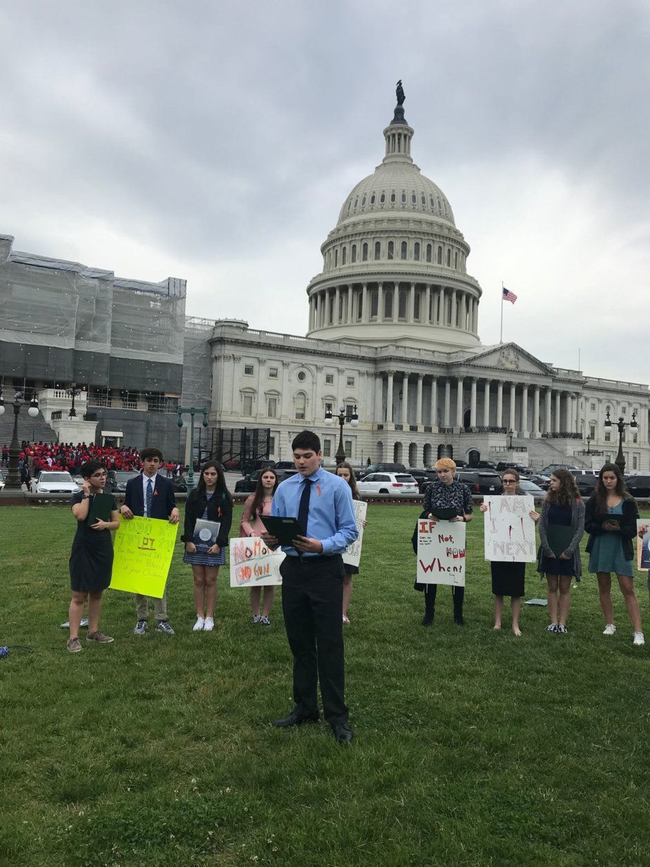 The group from Temple Emanuel, in Kensington, read the names of students who were killed last year at U.S. schools and held a moment of silence in front of the U.S. Capitol. (WTOP/Mitchell Miller)
