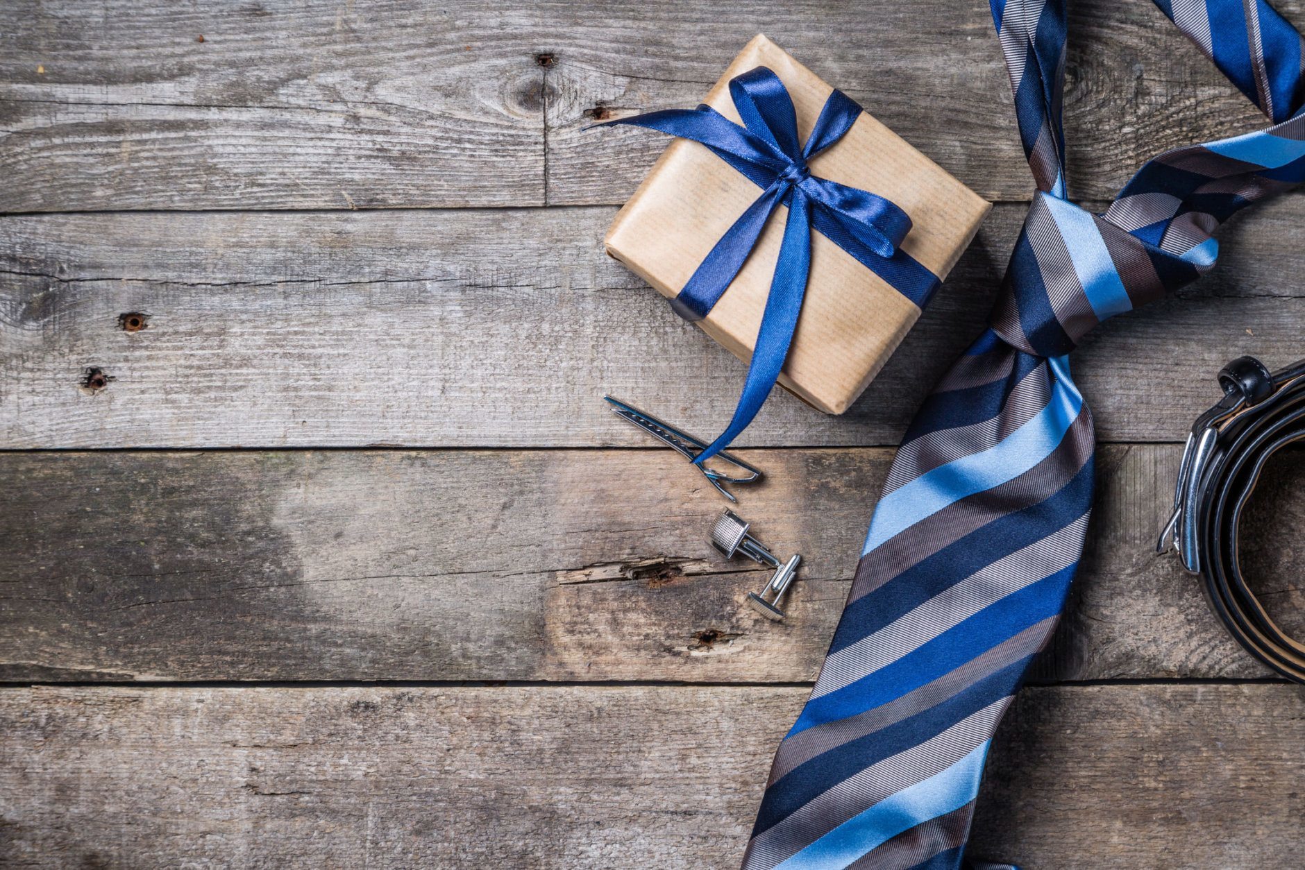 Father's day concept - present, tie on rustic wood background, top view