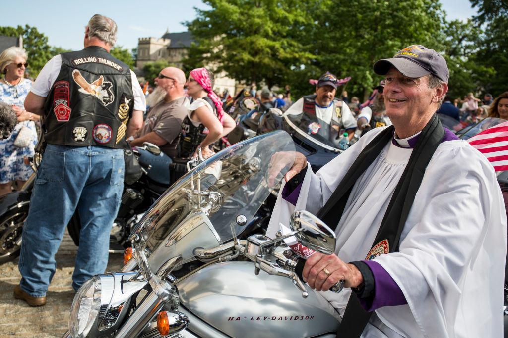 WASHINGTON, DC - MAY 24: The Rev. Stuart Kenworthy sits on a motorcycle during a blessing of the bikes event at the Washington National Cathedral on May 24, 2019 in Washington, DC. Rolling Thunder will mark the 32nd anniversary of its annual "Ride for Freedom" motorcycle procession and commemorative events this Memorial Day weekend for raising the attention of POW and MIA issues (Photo by Zach Gibson/Getty Images)
