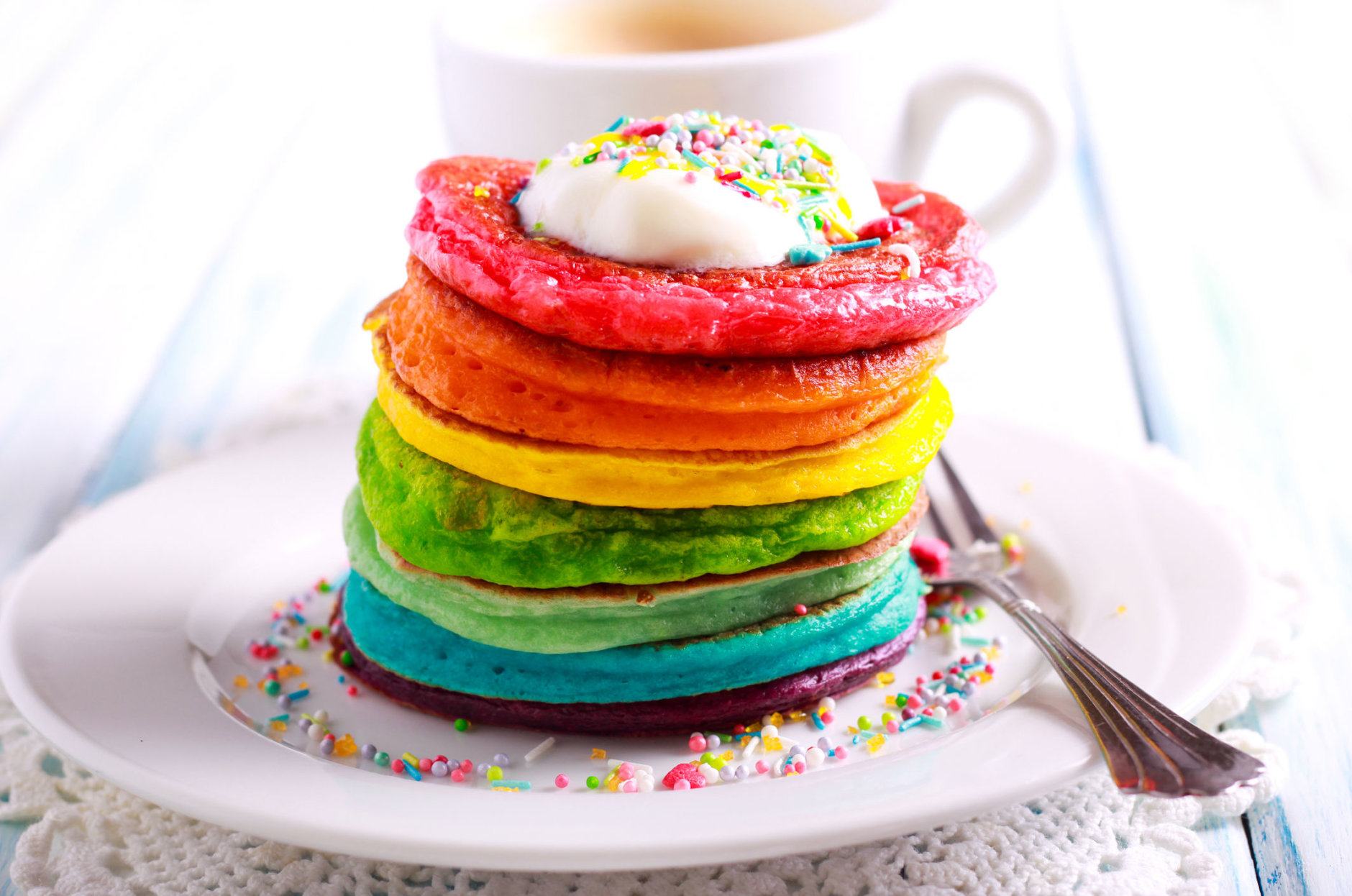 Rainbow pancakes, served in pile on plate
