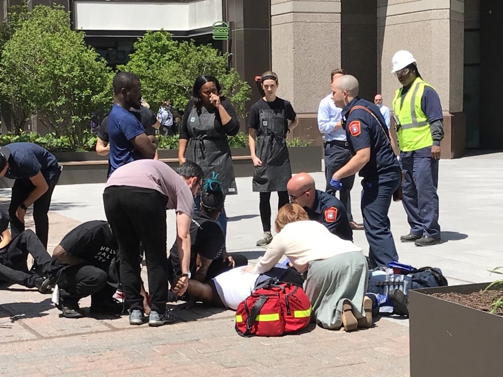 Medics and bystanders treating an injured kitchen worker in Ballston