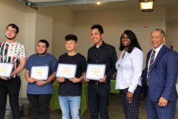 Conner McGuire, Marvin Gamez, Alexis Vivar Vargas and Francisco Rodriguez, the winners of $700 scholarships, are pictured with Prince George's County School Board member Sonya Williams and FACT Chair Howard Burnett. (WTOP/Kristi King)