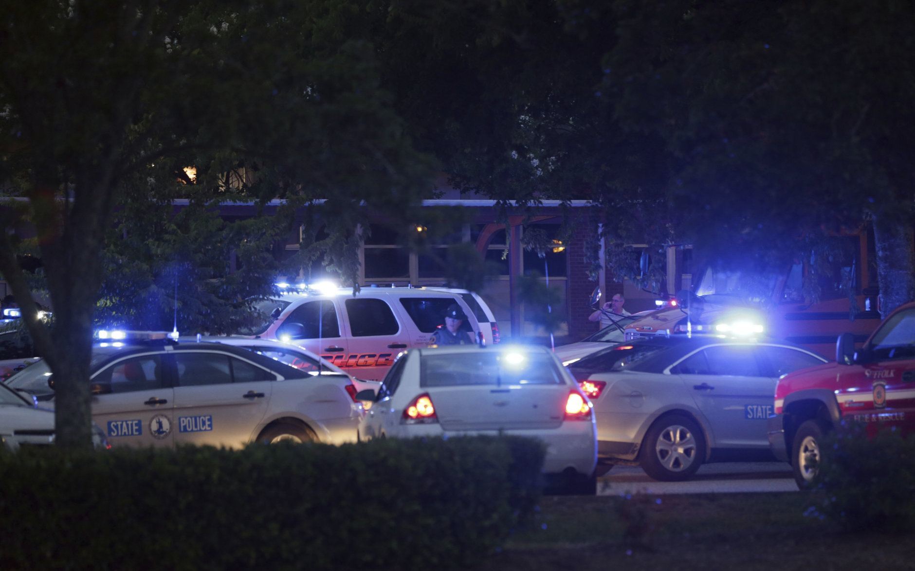 Emergency vehicles fill the parking lot at  the Princess Anne Middle School in Virginia Beach, Va, on Friday, May 31, 2019. A longtime city employee opened fire at a municipal building in Virginia Beach on Friday, killing 11 people before police shot and killed him, authorities said. Six other people were wounded in the shooting, including a police officer whose bulletproof vest saved his life, said Virginia Beach Police Chief James Cervera. (AP Photo/Vicki Cronis-Nohe)