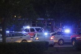 Emergency vehicles fill the parking lot at  the Princess Anne Middle School in Virginia Beach, Va, on Friday, May 31, 2019. A longtime city employee opened fire at a municipal building in Virginia Beach on Friday, killing 11 people before police shot and killed him, authorities said. Six other people were wounded in the shooting, including a police officer whose bulletproof vest saved his life, said Virginia Beach Police Chief James Cervera. (AP Photo/Vicki Cronis-Nohe)