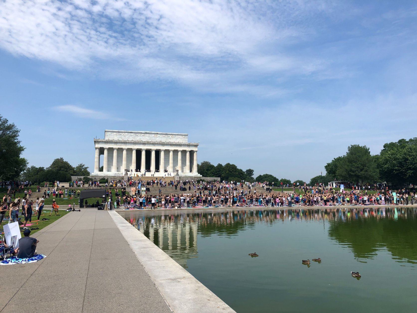 Thousands gathered in D.C. to practice yoga on the National Mall Sunday, May 19, 2019. (WTOP/Keara Dowd)