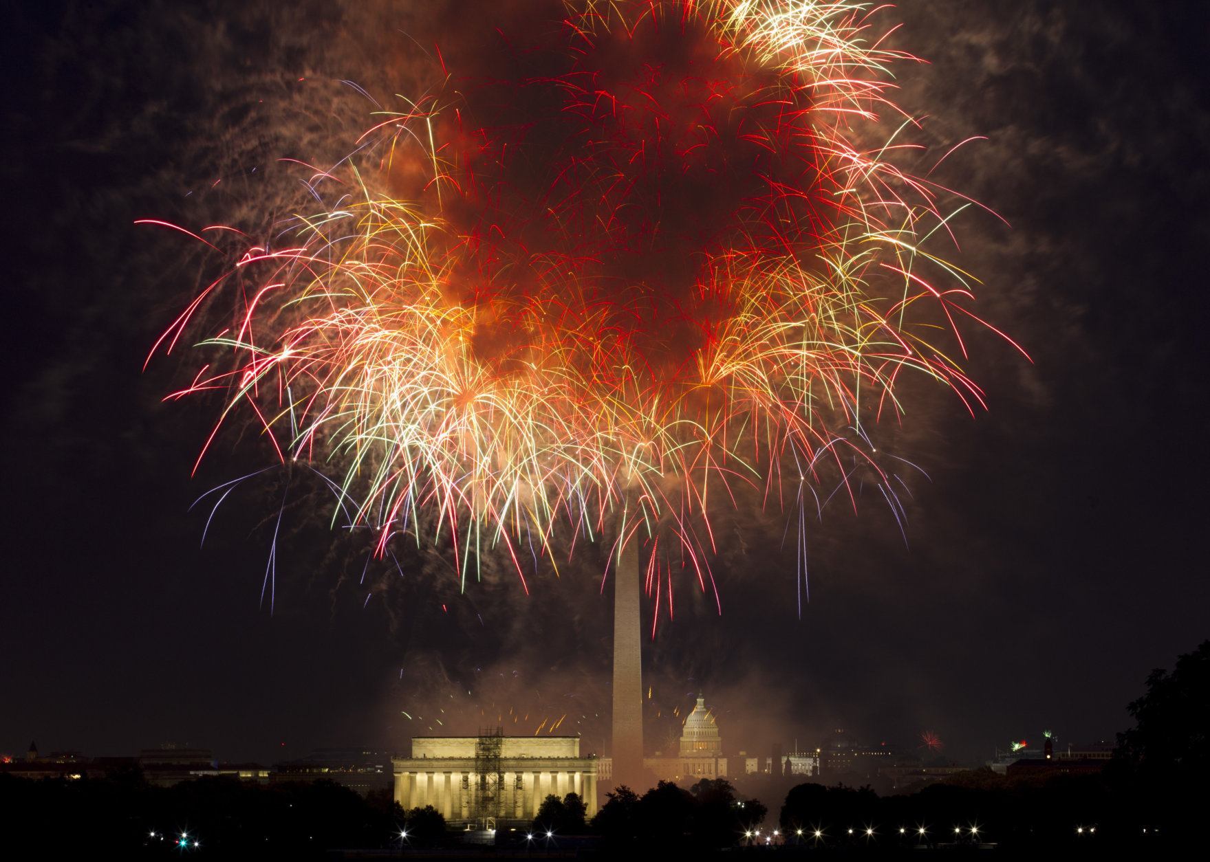 In this July 4, 2018, file photo, fireworks explode over Lincoln Memorial, Washington Monument and U.S. Capitol, along the National Mall in Washington, during the Fourth of July celebration. President Donald Trump has stated he wants to reshape the annual event into a “Salute to America” that would feature Trump himself speaking from the steps of the Lincoln Memorial. (AP Photo/Jose Luis Magana, File)