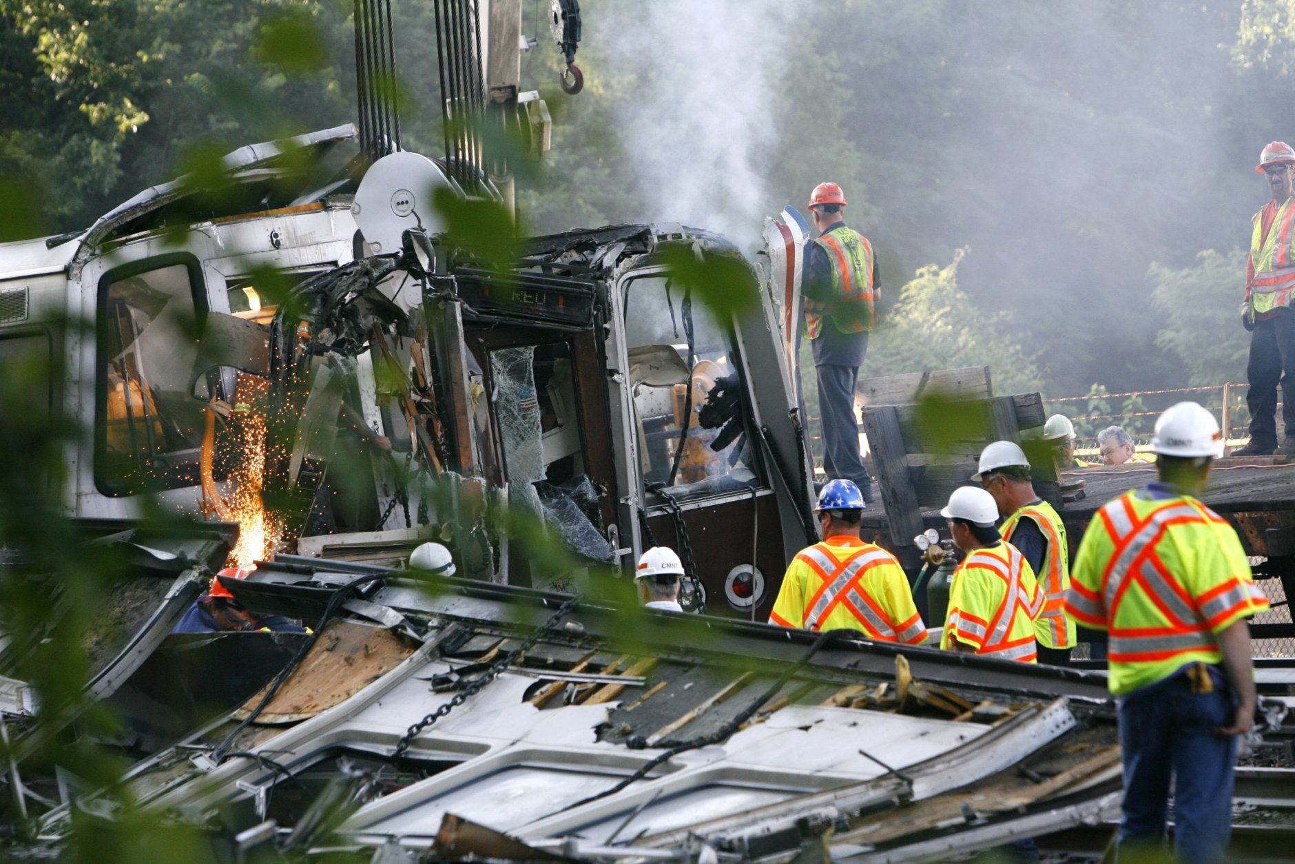 Officials continue to work around the scene of a rush-hour collision between two Metro transit trains in northeast Washington, D.C., Tuesday evening, June 23, 2009  (AP Photo/Jacquelyn Martin)