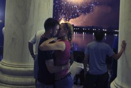 U.S. Marines Jenna Ahles, 20, of La Crosse, Wis., right, and Jack Eubanks, 25, of Kennesaw, Ga., kiss while fireworks explode over Washington while viewing from the Jefferson Memorial, Monday, July 4, 2011. (AP Photo/Cliff Owen)