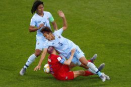 United States' Megan Rapinoe, centre, collides with Thailand's Ainon Phancha, right, as Kanjana Sung-Ngoen, left, watches during the Women's World Cup Group F soccer match between the United States and Thailand at the Stade Auguste-Delaune in Reims, France, Tuesday, June 11, 2019. (AP Photo/Francois Mori)